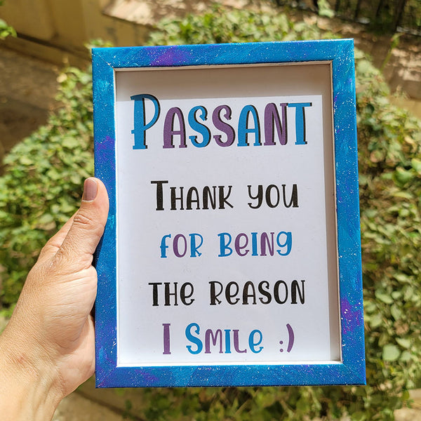 A Blue Galaxy Hand painted wooden frame with the following words written inside "Passant, Thank you for being the reason I smile:) "