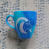 A Hand-painted blue galaxy mug with Capricorn sign in white and colored with patterns of pink,blues and greens