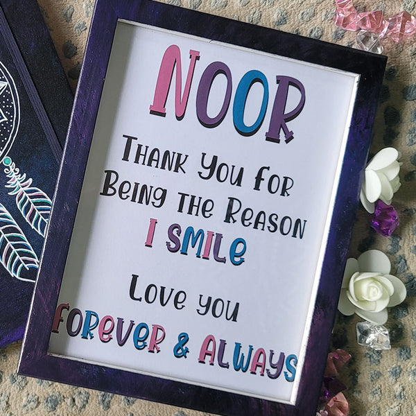 A Dark Sky hand painted wooden frame with the following written inside "Noor, Thank you for being the reason I smile. Love you, Forever and always"