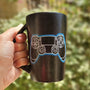 A Black sky mug with a joystick drawn on it