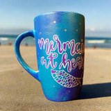 A blue hand painted mug with the words 