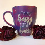 A reddish purple hand painted mug with the words 