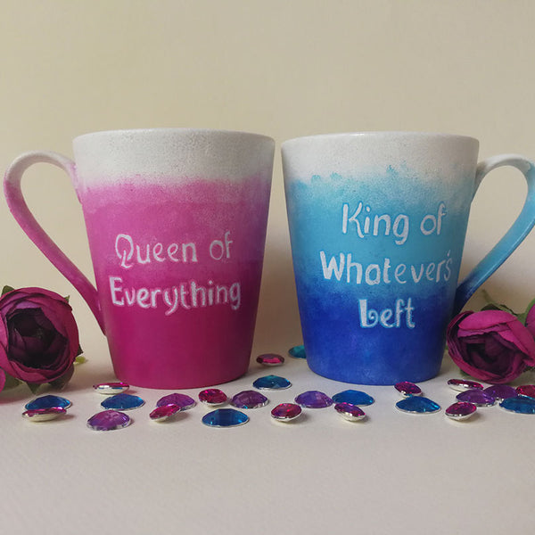 2 hand-painted mugs. One with gradients of pink and has the words "queen of everything" and the other is colored in gradients of blue and has the words "King of whatever's left"