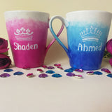 2 hand-painted mugs. One with gradients of pink and has the name 