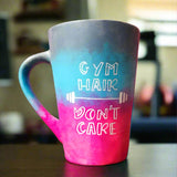 A gradient colored mug (from top grey then blue then pink) with the words 