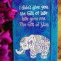 A Blue hand painted notebook with the words "I didnt give you the fit of life, Life gave me the gift of you" and a n elephant drawn below it in white and filled with patterns