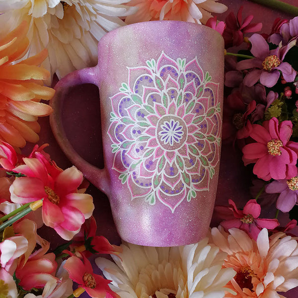 A Pastel Pink Hand Painted mug with a mandala painted in the center with white