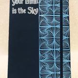 A Dark Blue Notebook with patterns drawn Vertically on half of the notebook top down and the the half has the words 