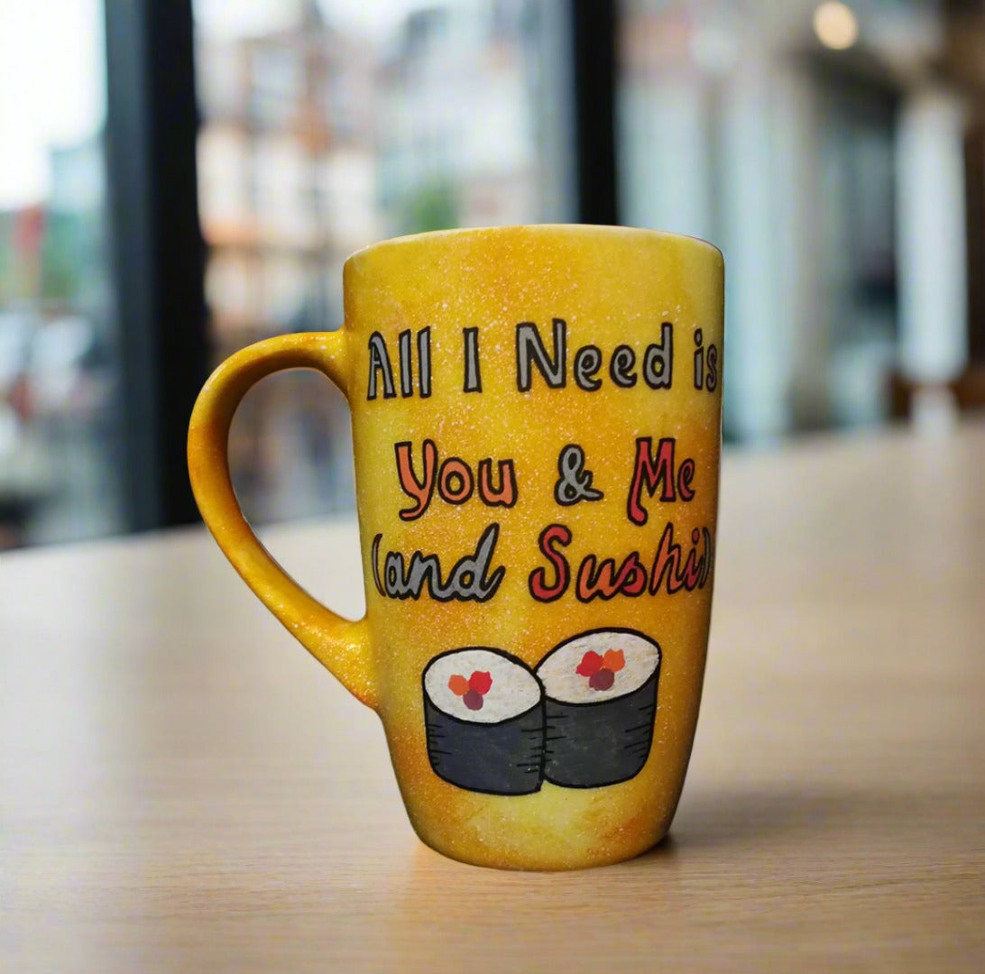 A Hand Painted Yellow Orange Galaxy Mug with the sentence "All I need is You and ME and Sushi" and 2 sushi rolls drawn below it