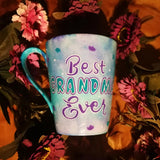 A pale blue purple  hand painted mug with the words 