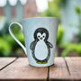 A baby blue hand painted mug with a zentangle baby penguin painted