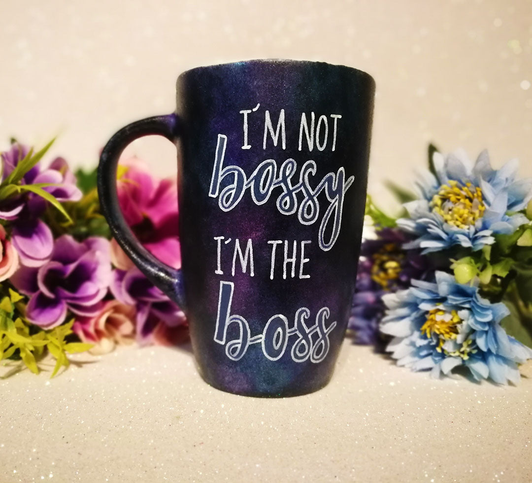 A Dark sky hand painted mug with the words "I'm not bossy , I'm the boss"