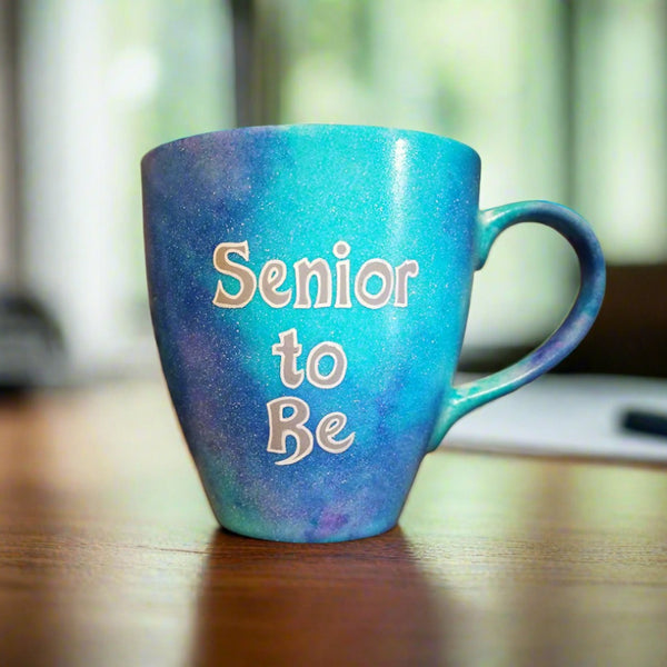 A Blue galaxy hand painted mug with the words "Senior to be"