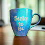 A Blue galaxy hand painted mug with the words "Senior to be"