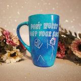 A hand painted blue galaxy mug with the words 