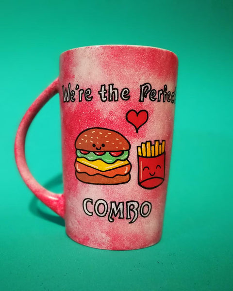 A hand-painted red galaxy mug with the words "we're the perfect combo"