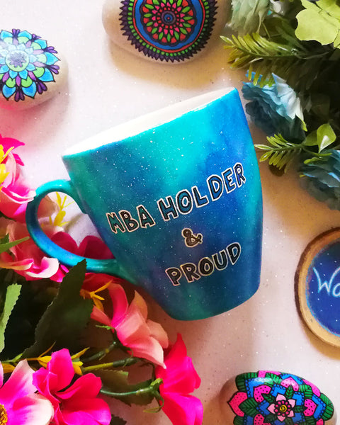 A Blue Galaxy hand painted mug with the words "MBA holder and proud"