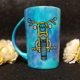 A Dark Sky Hand painted mug with a motorcycle front painted in black with patterns of yellow and greys