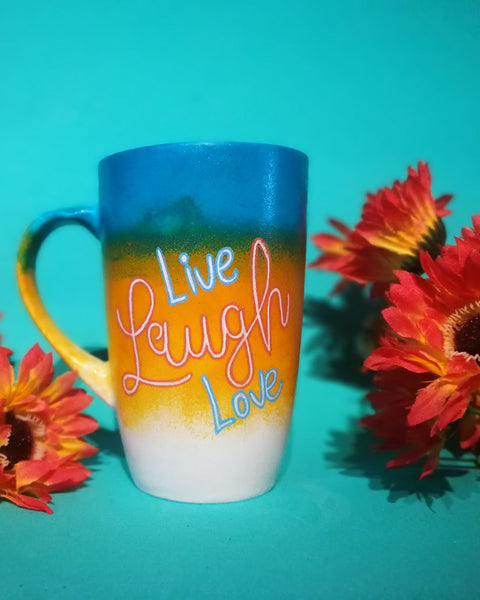 A gradient Hand Painted mug (from the top Blue, Bej and white) with the words Live Laugh Love