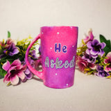 A hand-painted pink galaxy mug with the words 