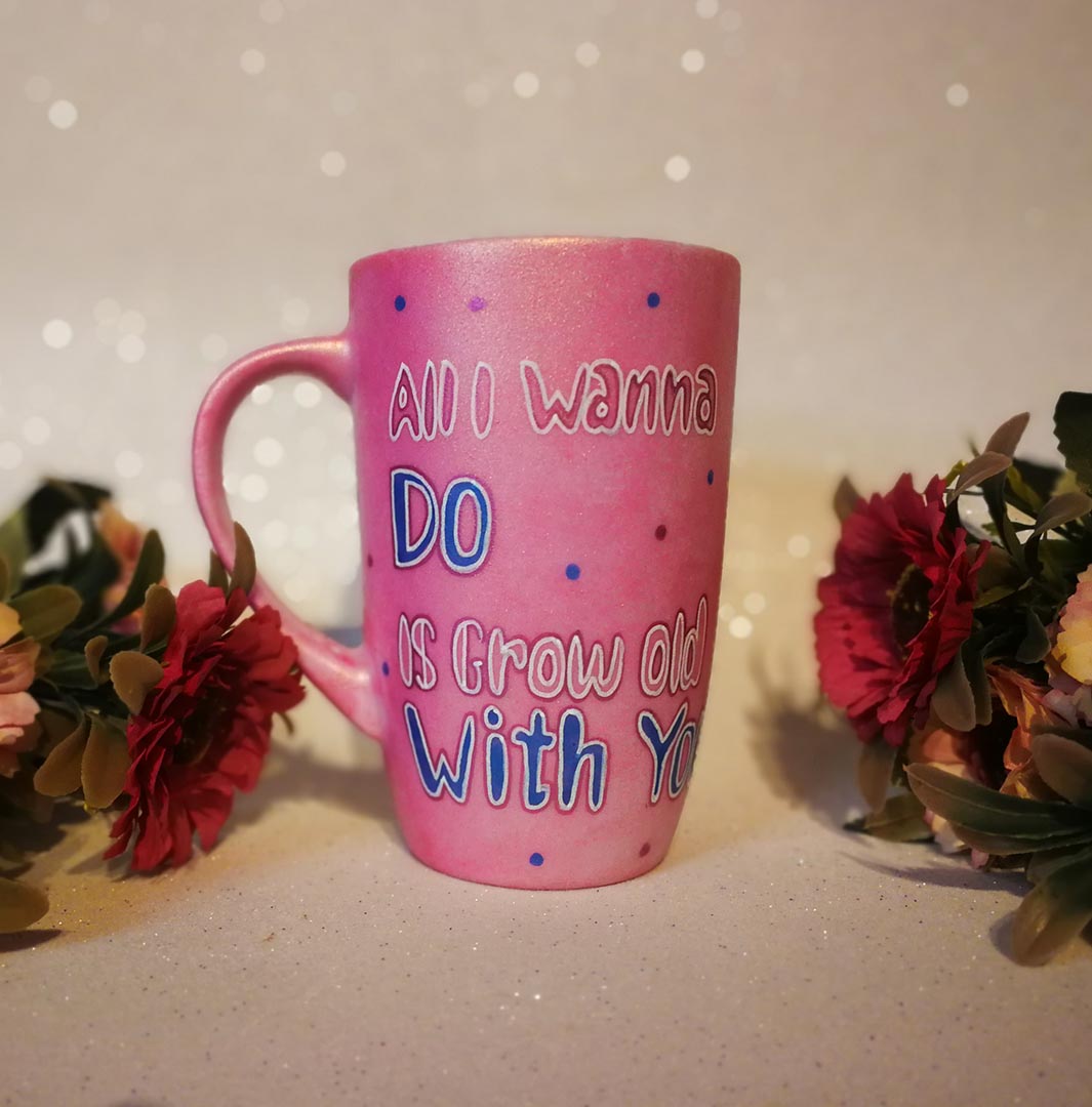 A hand-painted shimmery pink mug with the words