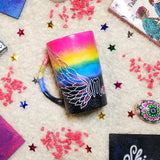 A gradient hand painted mug(rainbow colors in the top half and black galaxy in the bottom