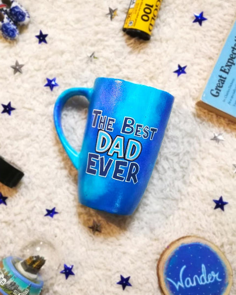 A blue hand painted mug with the words "The Best dad Ever"