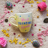 A Pastel yellow hand painted mug with the words 