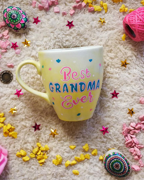 A Pastel yellow hand painted mug with the words "Best Grandma Ever"