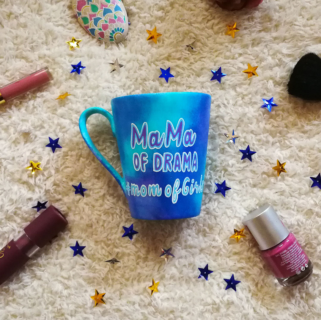 A blue hand painted mug with the words "mama of drama" and then below it #momofgirls