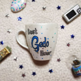 A hand painted pearl white mug with the words 