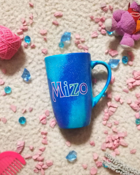 A blue galaxy hand painted mug with the name "Mizo"