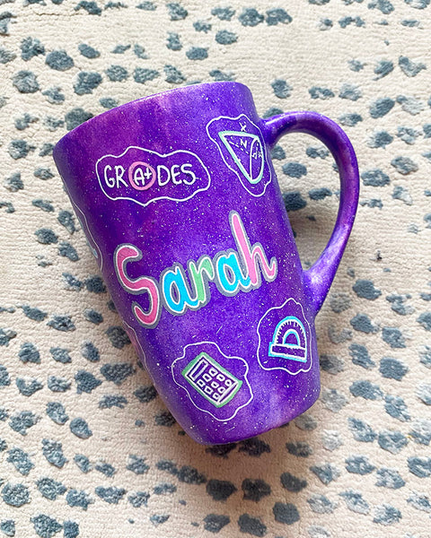 A Purple Galaxy Hand painted mug with the name "Sarah" and math icons scattered all over 