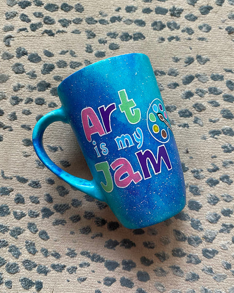 A Blue Galaxy Hand painted mug with the words "Art is my Jam" and a color palette drawn