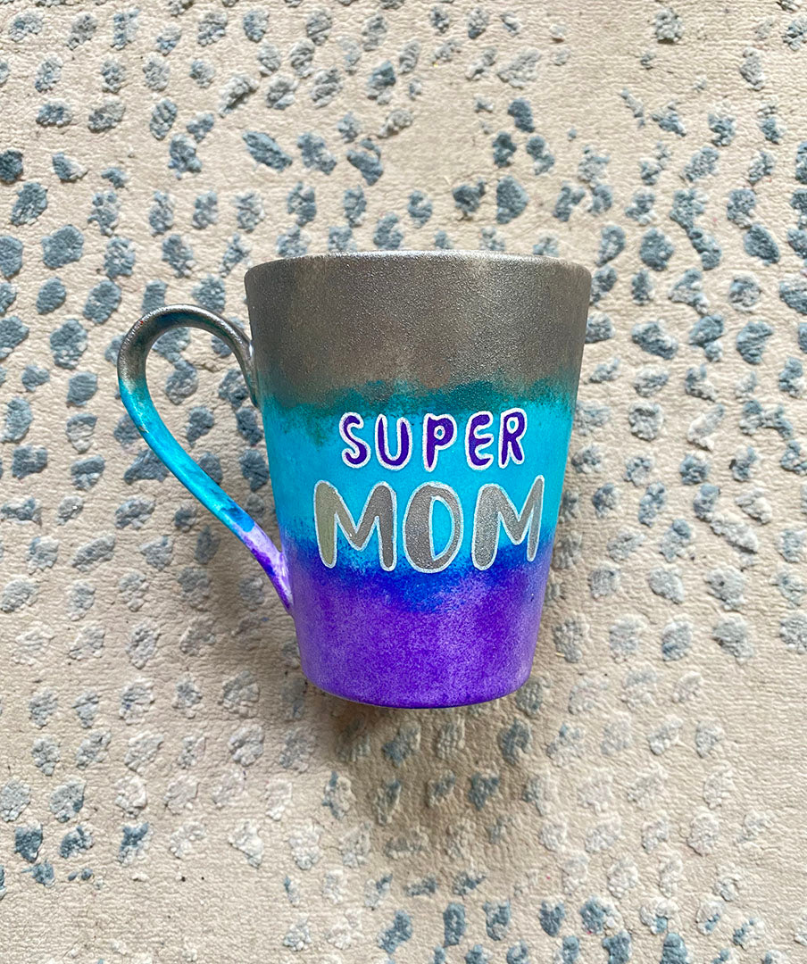 A Gradient colored mug (Silver blue and Purple) with the words "Super Mom" with pink dots scattered all over