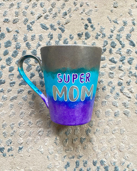 A Gradient colored mug (Silver blue and Purple) with the words "Super Mom" with pink dots scattered all over