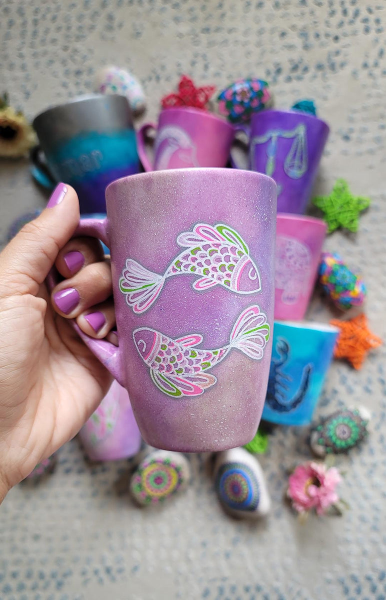 A Handpainted Pink Pastel mug with a Pisces design on it