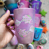 A Handpainted Pink Pastel mug with a Pisces design on it