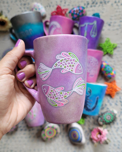 A Handpainted Pink Pastel mug with a Pisces design on it