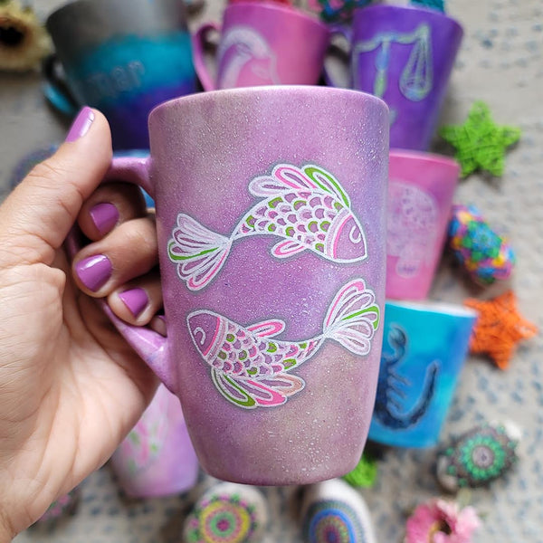 A Handpainted Pink Pastel mug with a Pisces design on it