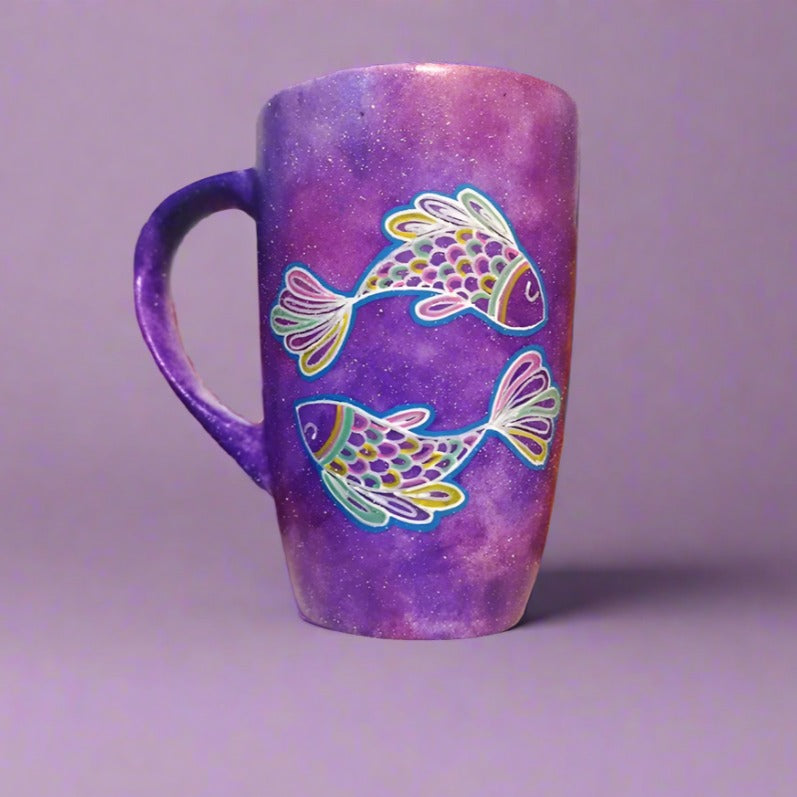 A Handpainted Purple galaxy mug with a Pisces design on it