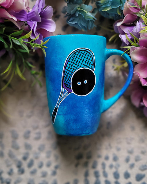 A Blue Hand painted mug with a drawing of a squash racket