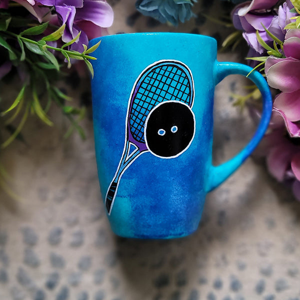 A Blue Hand painted mug with a drawing of a squash racket