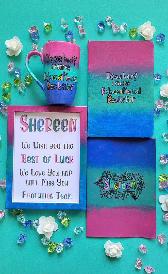 A Gift Set of a mug, notebook, wooden frame and card all painted in gradient colors of (pink-green-blue) . The mug and notebook have the sentence "Teacher? i prefer educational rockstar" and the card and frame has the name shereen