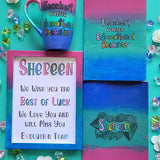 A Gift Set of a mug, notebook, wooden frame and card all painted in gradient colors of (pink-green-blue) . The mug and notebook have the sentence 