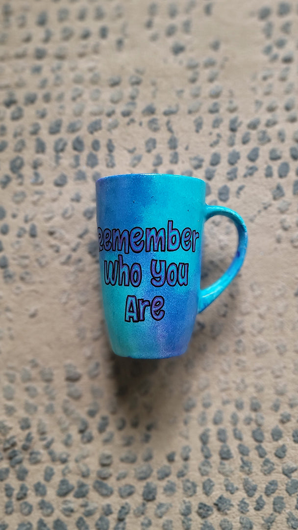 A Blue Hand painted mug with the words "remember who you are"