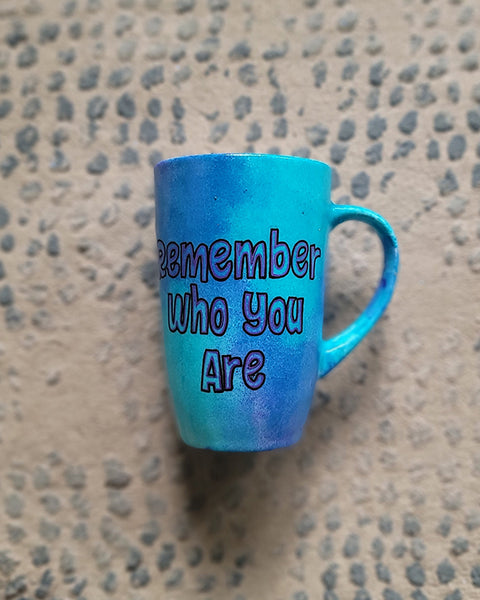 A Blue Hand painted mug with the words "remember who you are"