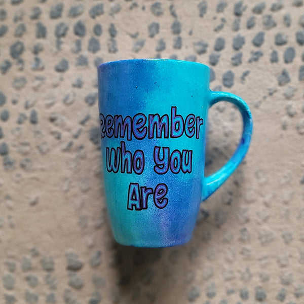 A Blue Hand painted mug with the words "remember who you are"