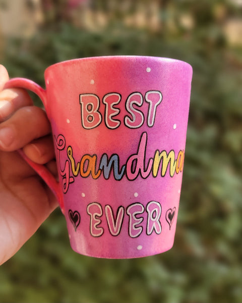 A Pink hand painted mug with the words "Best Grandma Ever"