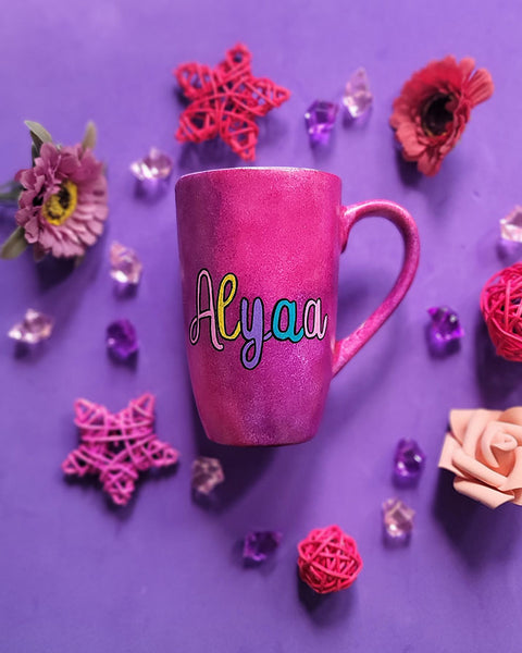 An indian pink hand painted mug with the name Alyaa